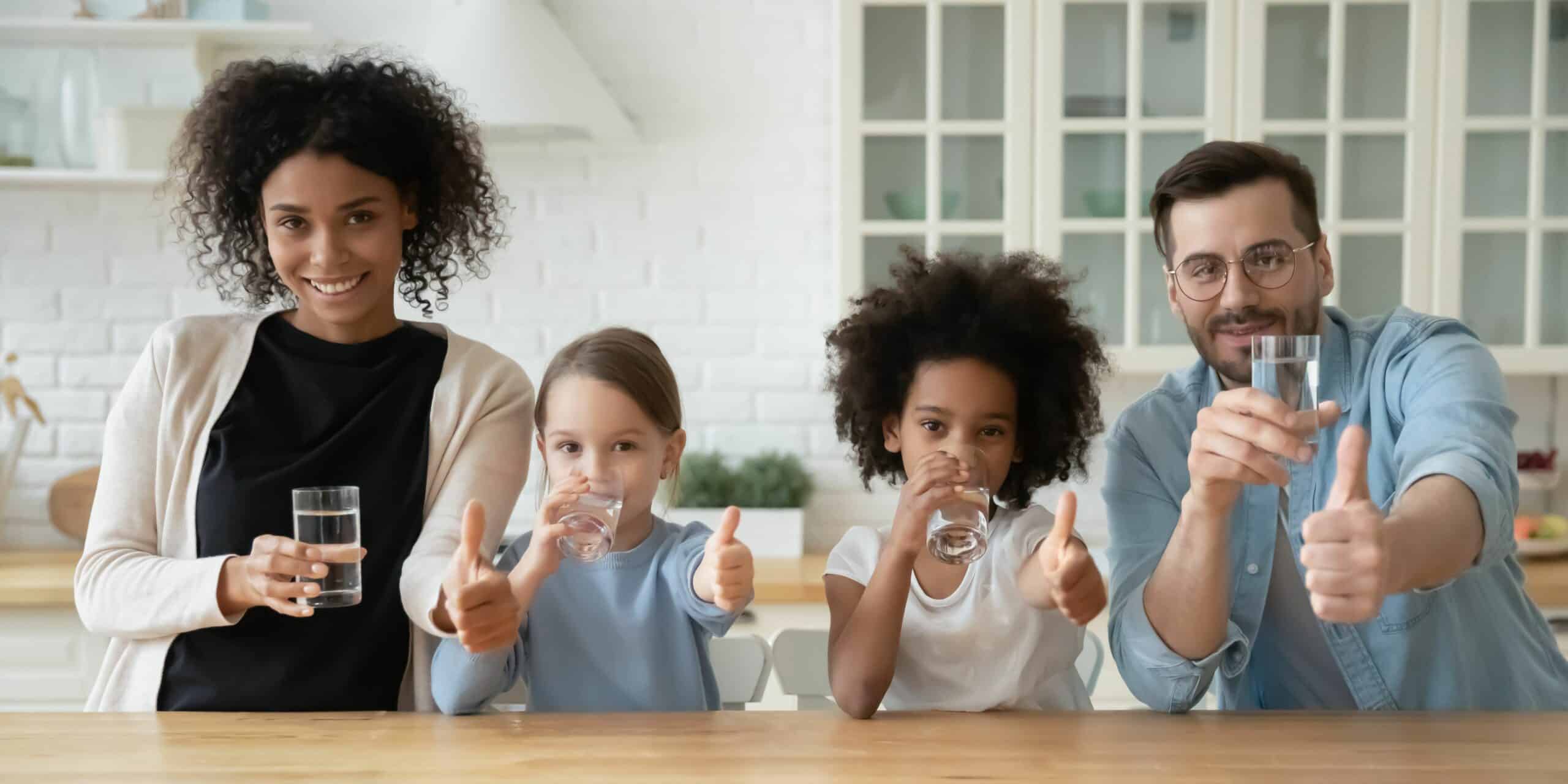 A family drinking a glass of water.