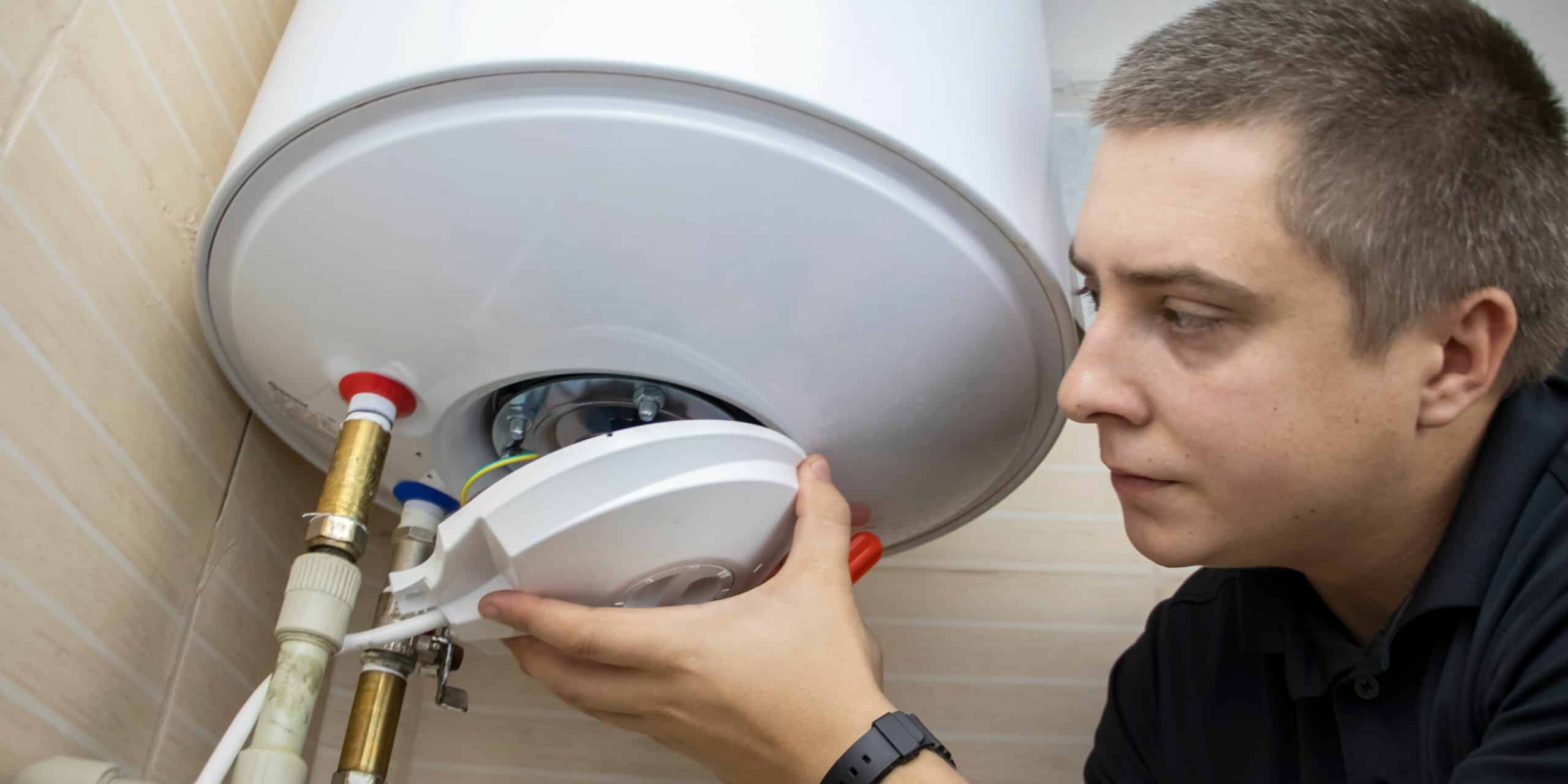 Man insulating a water tank